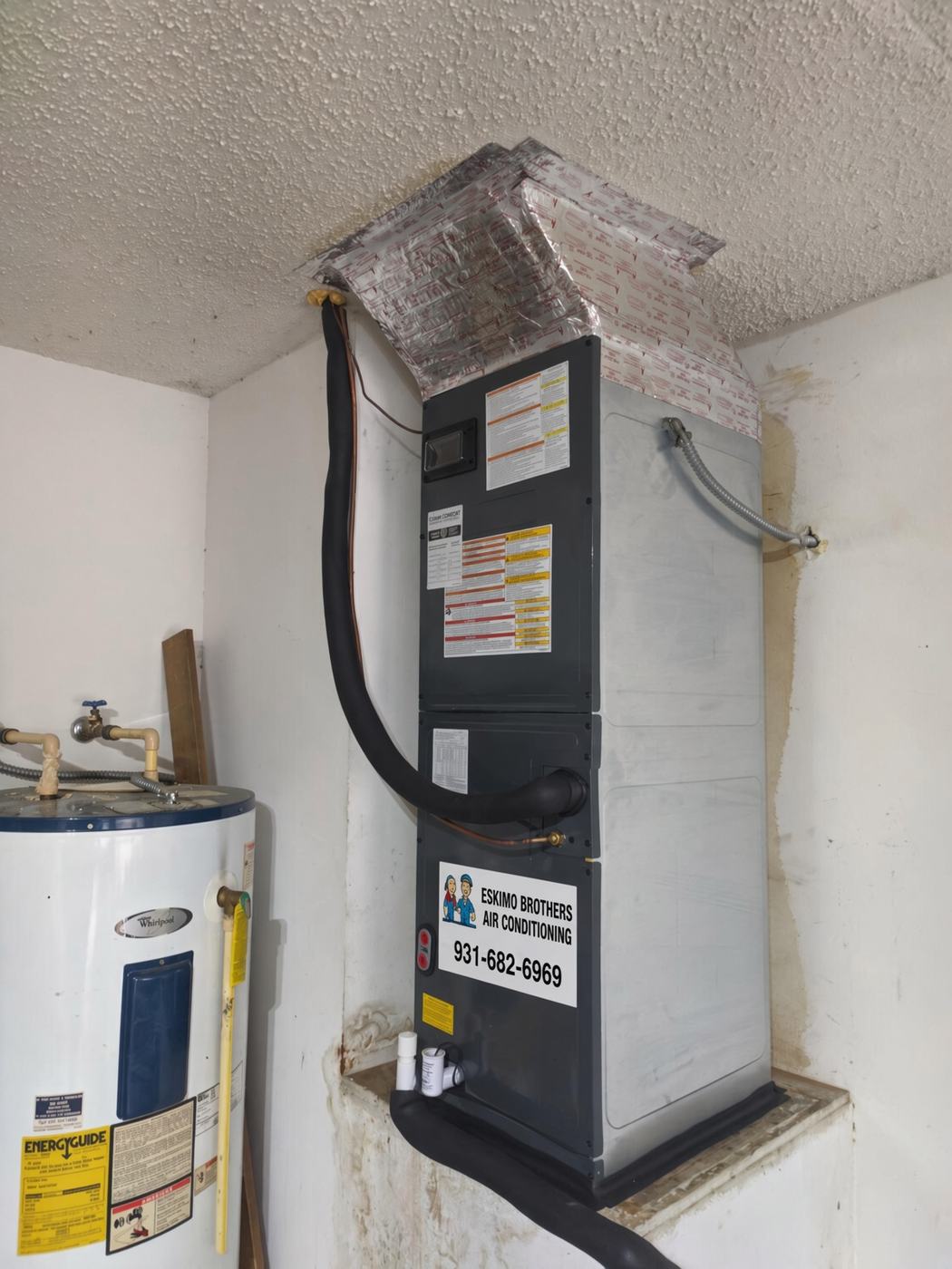 AC installation in Spring Hill TN — air handler with Eskimo Brothers 931-682-6969 sticker
